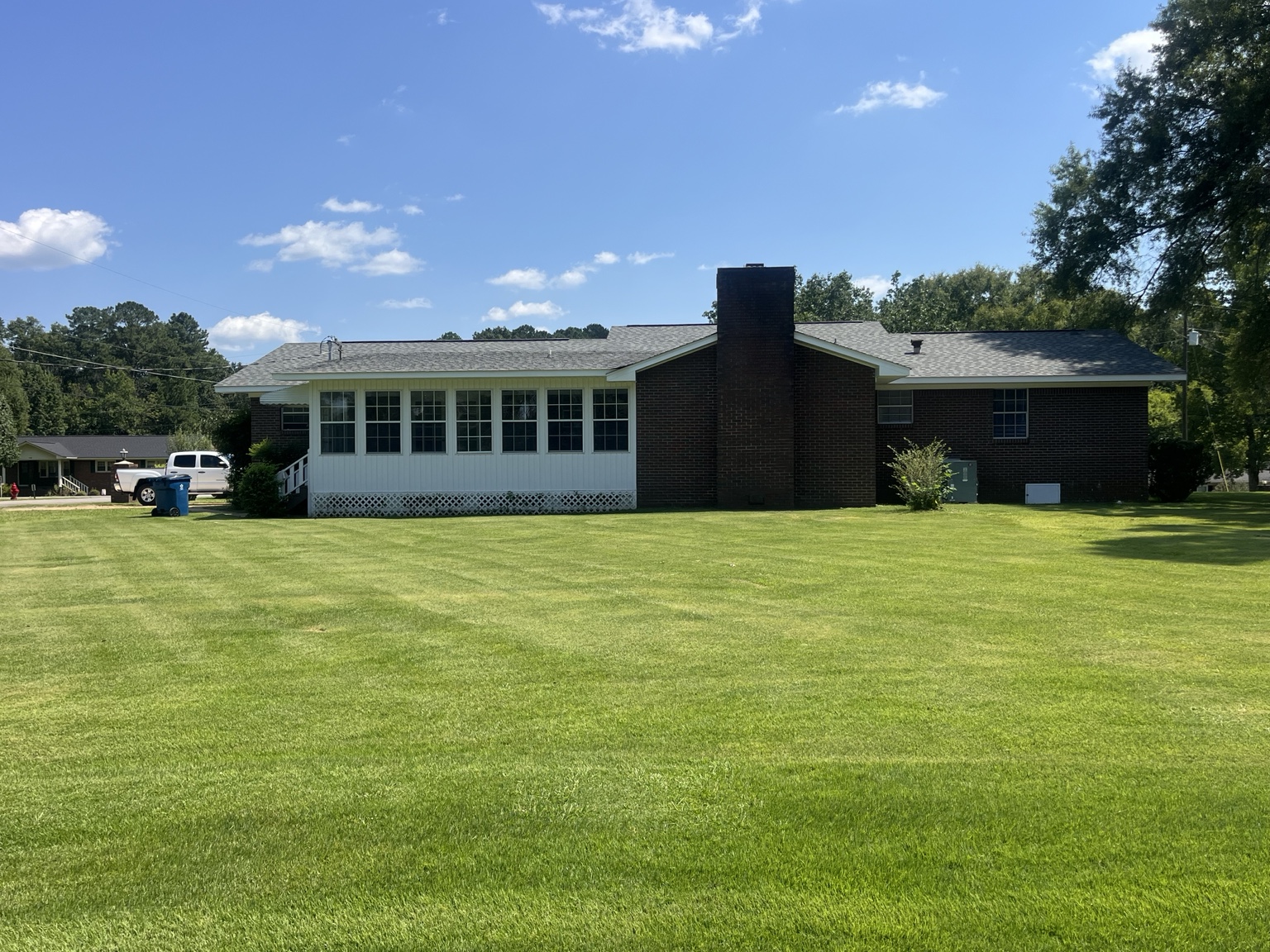Large lawn behind the brick home