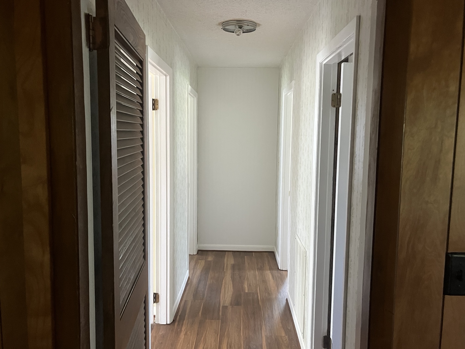 Interior hallway with wood-look flooring