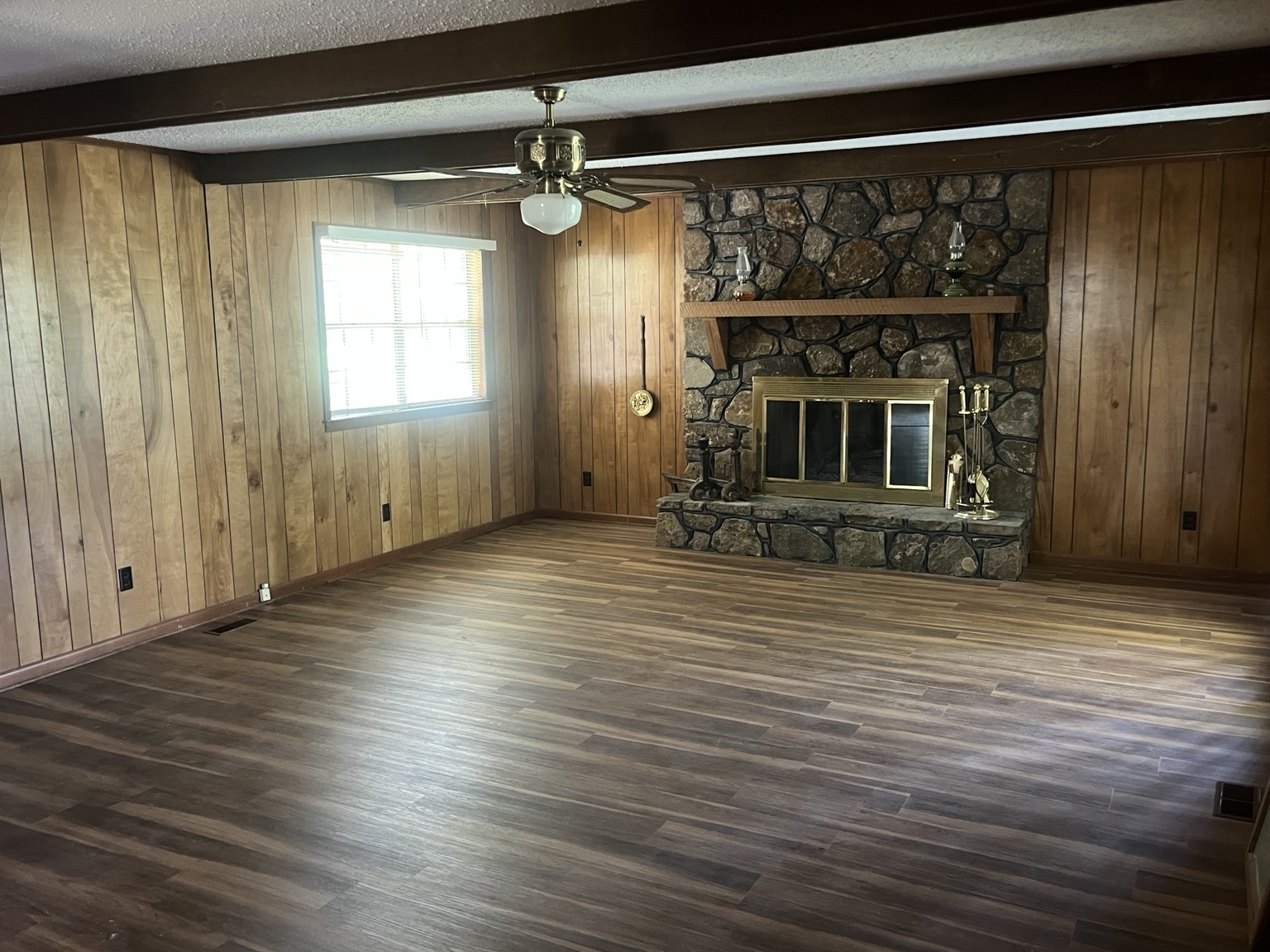 Spacious living room with stone fireplace